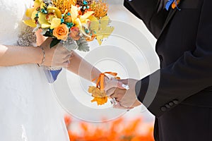 Bride and bridegroom hand in hand