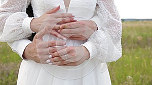 Bride and bridegroom hugs each other's wedding rings