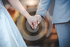 Bride and bridegroom married hands when sun is falling.