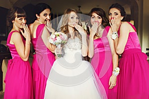 Bride and bridesmaids flirt standing in the restaurant