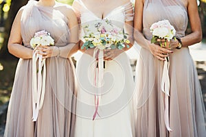 Bride and bridesmaids with autumn bouquets