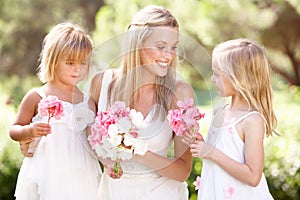 Bride With Bridesmaids Outdoors At Wedding