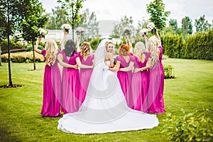 Bride with bridesmaids in a park