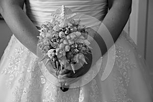 Bride carrying elaborate seashell bouquet for her wedding day
