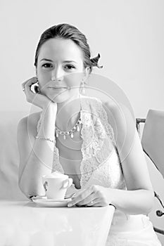 Bride with cup of coffee.