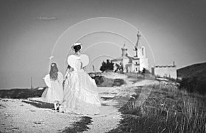 Bride and daughter with wings going to church