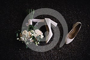 Bride detail soft bouquet and beige shoes. Concept of stylish wedding