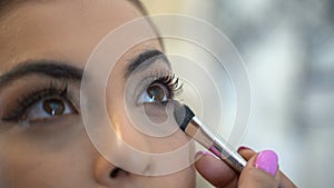 Bride doing eye makeup. close-up makeup mirror. eyes close up weddimg
