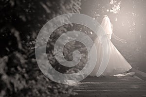 Bride doing pirouette in the park