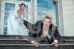 Bride dragging groom at the wedding. photo