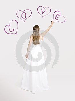 Bride drawing hearts on the wall