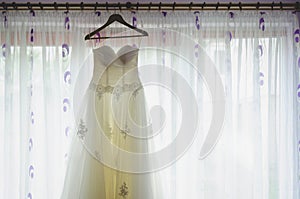 Bride dress in front of window