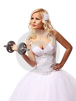 Bride with dumbbell. beautiful blonde young woman in wedding dress isolated