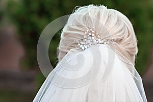 Bride with elegant hairstyle.close up bride`s hairstyle with a veil back