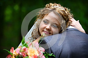 Bride embracing groom