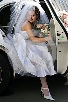 Bride exiting wedding car limo photo