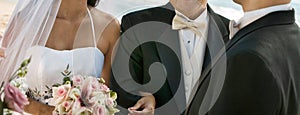 Bride and Father Arm in Arm With Groom