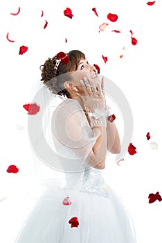 bride on floor among red rose petals