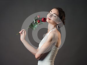 Bride with a flower. Beautiful woman with red roses