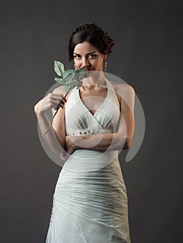 Bride with a flower. Beautiful woman with red roses