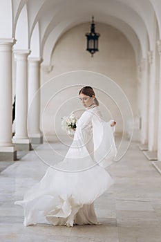 The bride in a flowing wedding dress. Castle wedding.