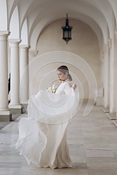 The bride in a flowing wedding dress. Castle wedding.