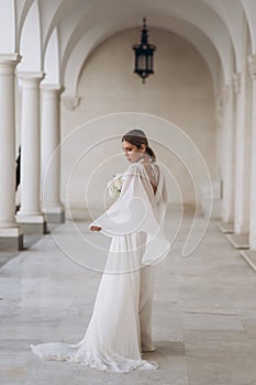 The bride in a flowing wedding dress. Castle wedding.