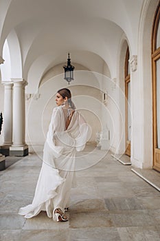 The bride in a flowing wedding dress. Castle wedding.