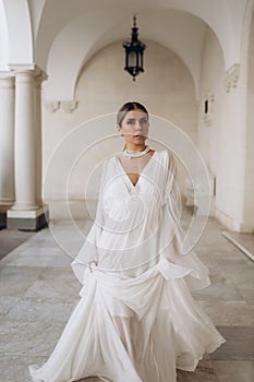 The bride in a flowing wedding dress. Castle wedding.