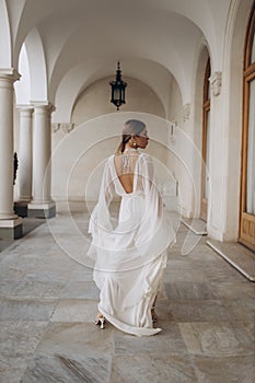 The bride in a flowing wedding dress. Castle wedding.