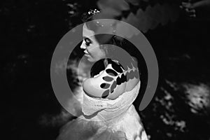 Bride in the forest with shade leaves