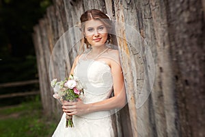 Bride in front of wooden fence portrait
