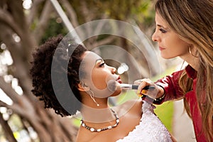 Bride getting her make up touched up