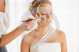 Bride getting her makeup fixed