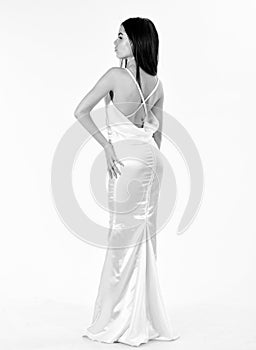 Bride, girl in graceful dress. Fashion model demonstrate expensive fashionable evening dress or wedding dress. Fashion