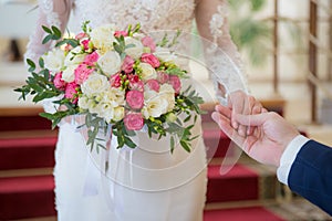 The bride gives her hand to the groom. Bride`s hand.