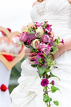 Bride in gown with bridal bouquet and doves