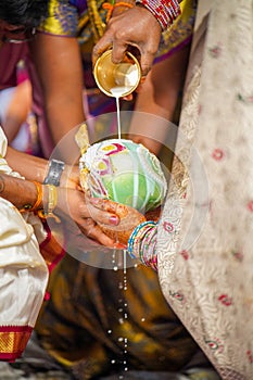 The bride grabbed the coconut husk