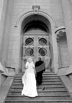 Bride and groom ascend stairs photo