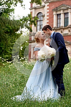 Bride and groom on the background of an old estate. Classical wedding.Wedding walk and photo shoot. Embraces and kiss