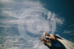 bride and groom on the background of sky