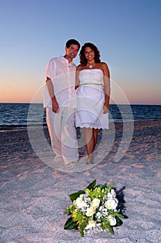 Bride and groom on beach