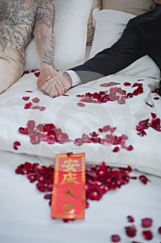 Bride and Groom on a Bed in Wedding Day, Asian culture