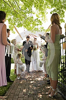 Bride And Groom Being Showered With Flower Petals