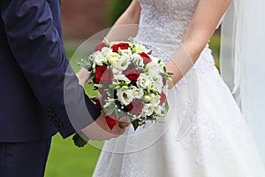 Bride and groom with bridal bouquet photo