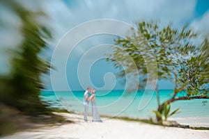 Bride and groom on a Caribbean beach, Lensbaby artistic blur, photo