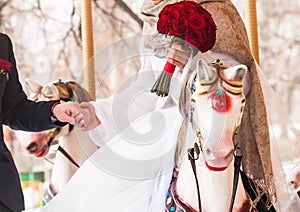 Bride and groom in a carousel on their wedding day