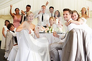 Bride And Groom Celebrating With Guests At Reception