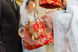 Bride and groom during a Christian wedding ceremony. Traditional headdresses. Slavic wedding.