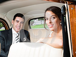 Bride and groom in a classic car